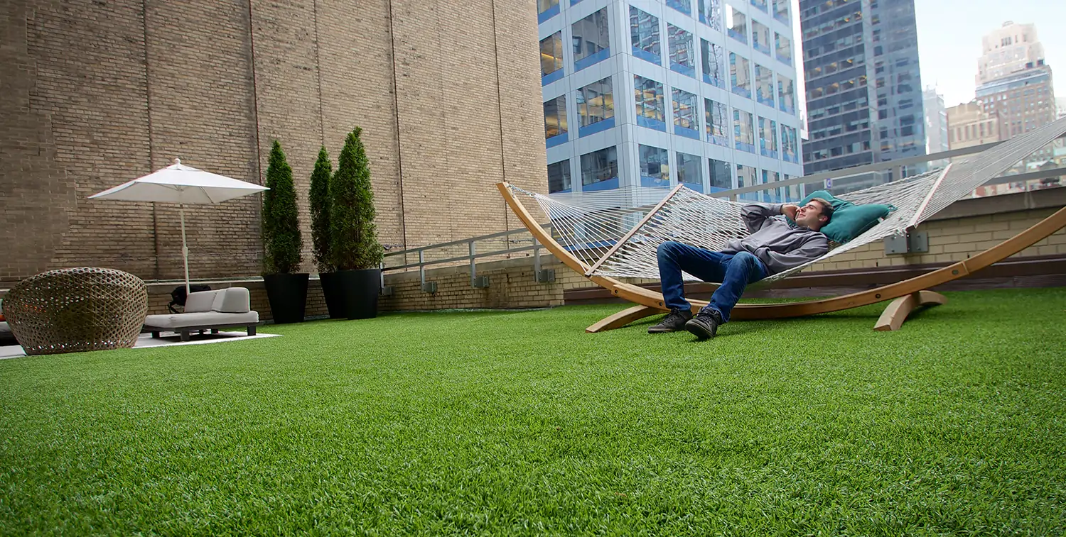 Man relaxing on artificial grass patio from SYNLawn