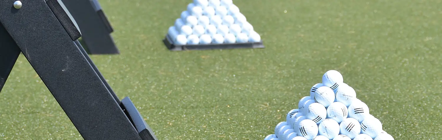 Stacked golf balls artificial grass